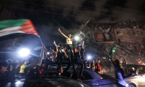 Palestinians celebrate the ceasefire brokered by Egypt between Israel and Hamas in Gaza City 