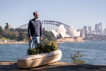 Loop Biotech founder Bob Hendrikx stands next to the mushroom coffin in Sydney harbour