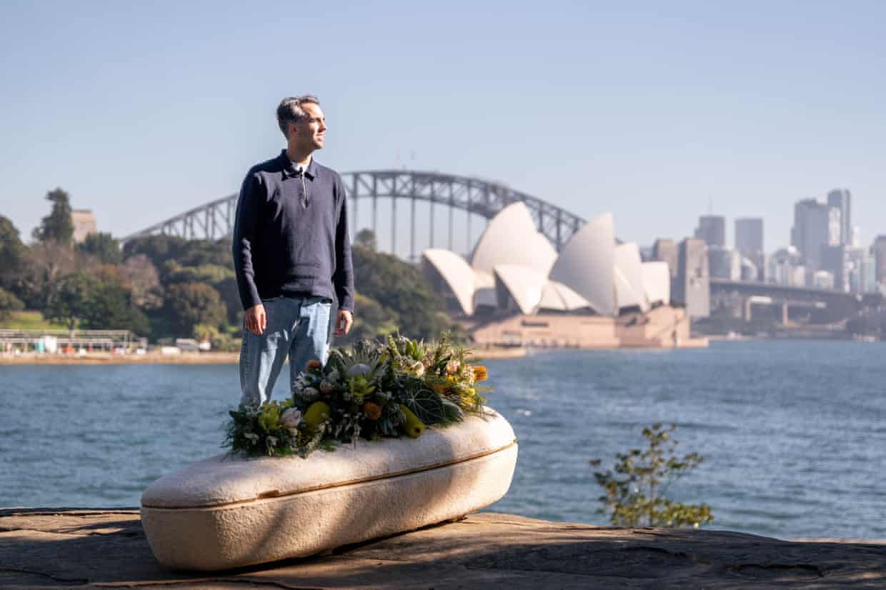 Loop Biotech founder Bob Hendrikx stands next to the mushroom coffin in Sydney harbour