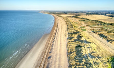 An aerial shot of the sea and dunes.