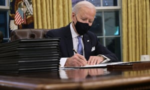 Joe Biden prepares to sign a series of executive orders at the Resolute Bureau.