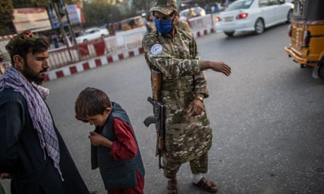A Taliban police officer slaps a boy for loitering. Force is now supposed to be a last resort, according to Kandahar’s new vice and virtue chief.