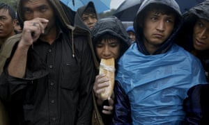 Afghan migrants wait to be registered at a camp on the Greek island of Lesbos