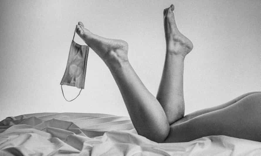 Female model in bed with mask on one foot