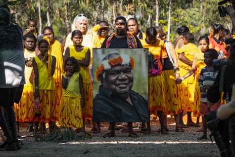 Members and family of the Gumatj Clan hold a portrait of the late Dr. Yunupingu as they walk down the middle of the Garrtjambal Auditorium during Garma Festival 2022 at Gulkula on August 04, 2023 in East Arnhem, Australia.