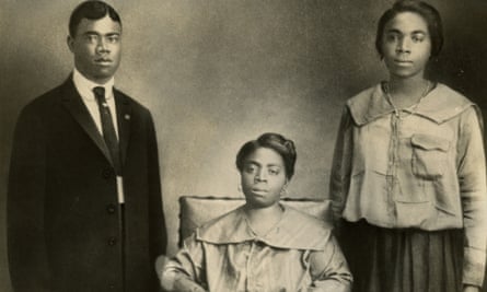 Jazz trumpeter and singer Louis Armstrong poses for a portrait with his mother, Mary Albert (seated), and sister Beatrice ‘Mama Lucy’ Armstrong in New Orleans, Louisiana.