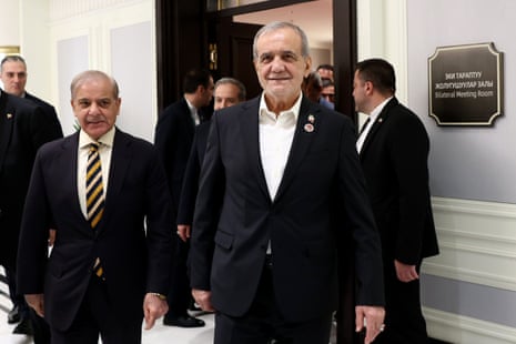 Pakistani prime minister Shehbaz Sharif and Iranian president Masoud Pezeshkian walking together at the summit.