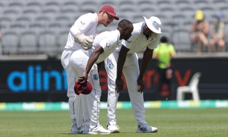 Kemar Roach of the West Indies leaves the field injured after bowling during Day 4 of the First Test between Australia and the West Indies