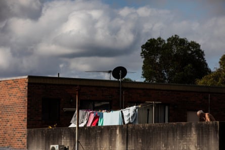 Clothes on a washing line in a backyard at the rear of a brick building