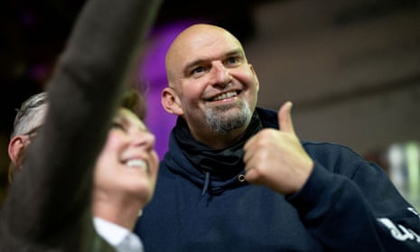 fetterman gives thumbs up while woman smiles