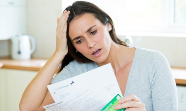 Worried woman looking at bank statement