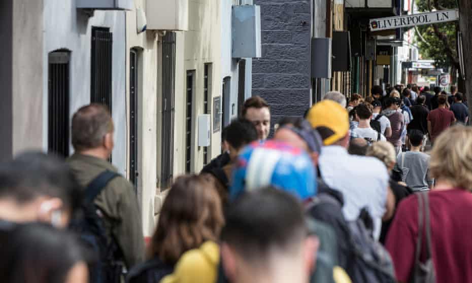 People queue along Crown Street for up to two blocks to get into the Darlinghurst Centrelink offices , 23 March 2020. 