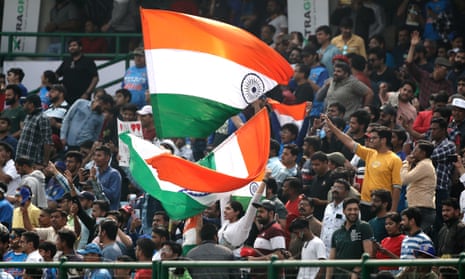 Indian fans wave flags in the stands