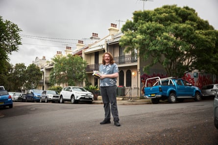 Hayden Fisher, who works in a Sydney book store, standing outdoors on a street