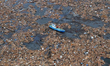 A boat surrounded by some of the debris washed out to sea by Japan’s 2011 tsunami.