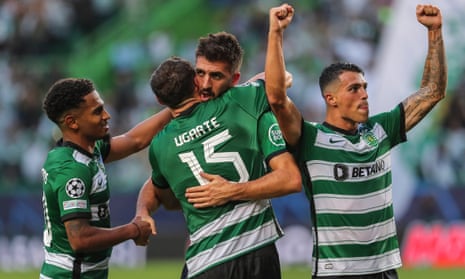 Sporting player Paulinho celebrates with team-mates after scoring the opening goal.