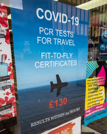 A poster in the window of a pharmacy offering commercial Covid-19 PCR test for travel.