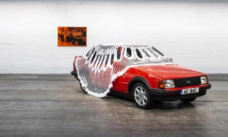 Red Ford Escort in gallery with doily on top