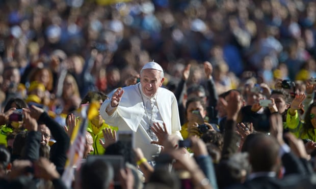 Pope Francis salutes the crowd as he arrives in St Peter's square at the Vatican on 6 November  2013.