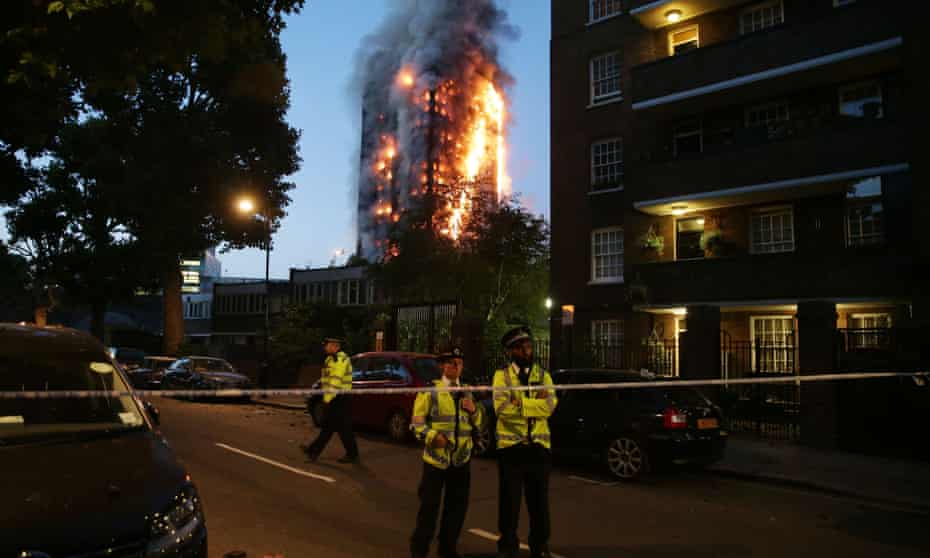 Police man a security cordon as the Grenfell Tower fire rages.