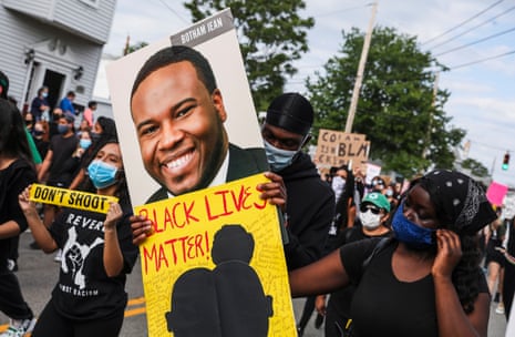 people hold signs at a protest