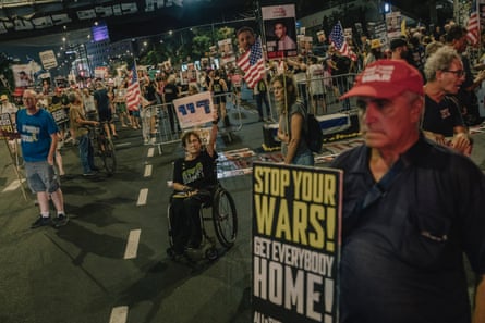 Protesters carry placards with messages including ‘Stop your wars! Get everybody home!’