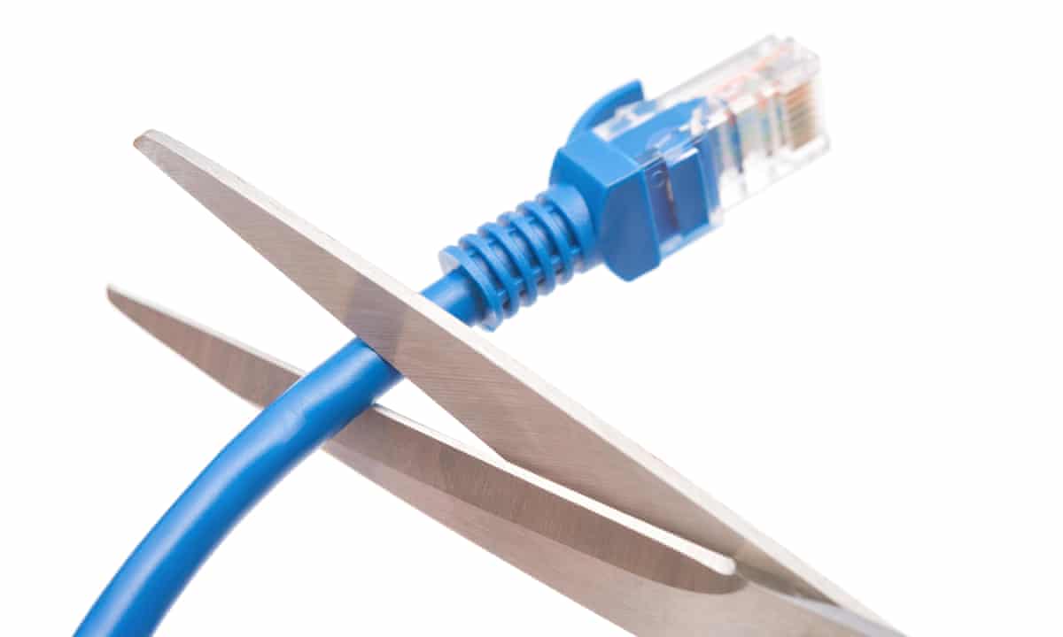 Cutting a blue network cable with scissors