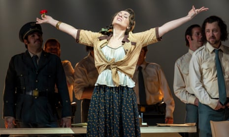 Justina Gringytė holds her arms wide, a rose in one hand, as Carmen in Scottish Opera's production.