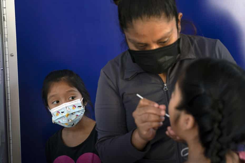 At a test site in Los Angeles this month, Katie Ramirez, left, sees her mother, Claudia Campos, licking the mouth of another daughter, Hayley.