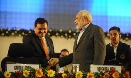 Gautam Adani (L) shakes hands with Narendra Modi, then the chief minister of Gujarat, at a summit in 2011.