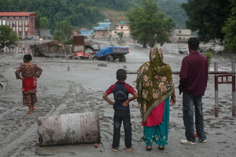 People observe the aftermath of flooding in Nuwakot, Nepal