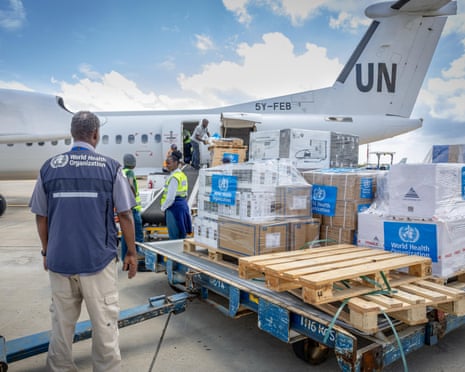 Workers with pallets of supplies about to be loaded on to a UN plane