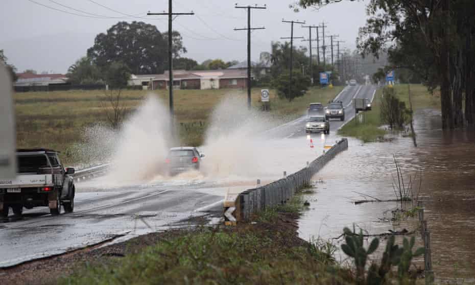 A driver chances their hand on a flooded section of Plainland-Laidley road on Friday. Queensland continues to be battered by wet weather, with emergency alerts issued and warnings of flash floods today. Follow Qld flooding live updates