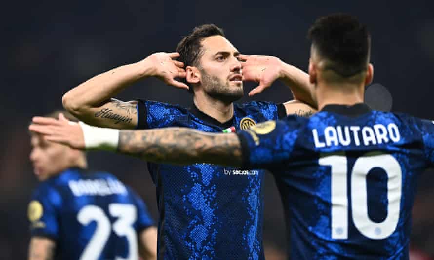Inter’s Hakan Calhanoglu celebrates by cupping his ears towards the fans after scoring against his former club Milan.
