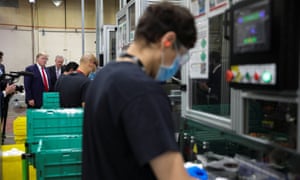 Trump watches workers create protective face masks at the Honeywell facility.