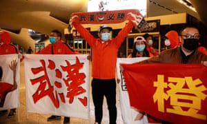 Supporters welcome the team back at Wuhan train station after more than three months away.