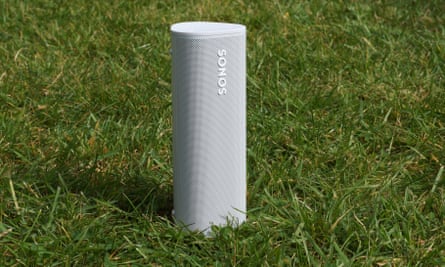 Sonos Roam speaker standing on a patch of grass.