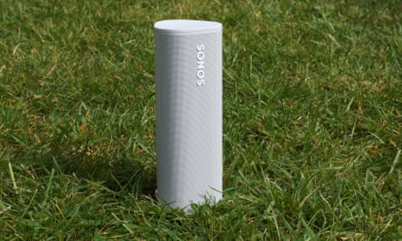 A Sonos Roam speaker on the lawn.