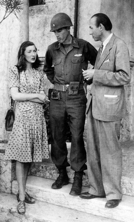 Actress Corinne Luchaire stands next to a US soldier and her father Jean Luchaire in May 1945