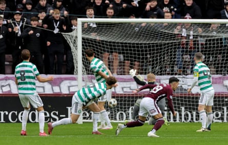 Fans start to rejoice as Alexandros Kyziridis watches the ball nestle in the Celtic net