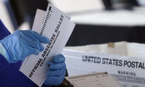 A person holds absentee ballots.