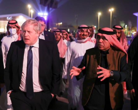 Boris Johnson and Majid al-Qasabi walking together at the head of a group of officials