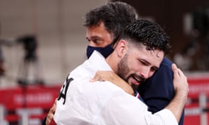 Ariel Torres hugs his coach after winning kata bronze.