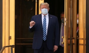 US President Donald Trump makes a fist as he walks out the front doors of Walter Reed National Military Medical Center after a fourth day of treatment for the coronavirus disease (COVID-19) as he heads to the Marine One helicopter to return to the White House in Washington from the hospital in Bethesda, Maryland, US, 5 October 2020.