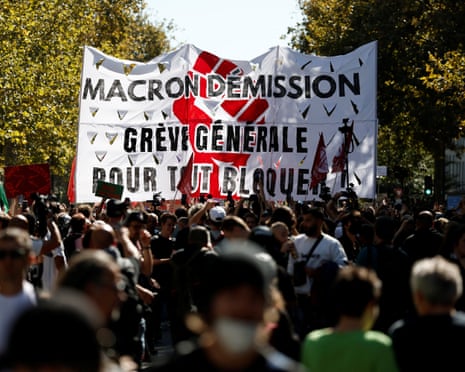 A large banner held over marchers in the street