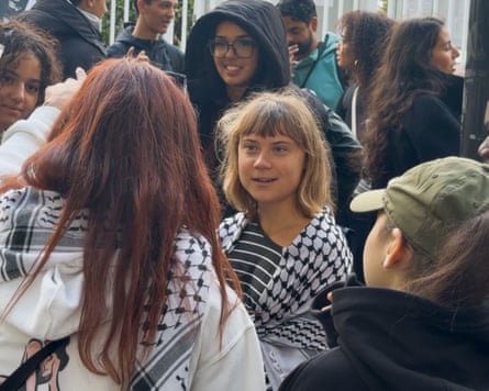 Thunberg, with a keffiyeh around her shoulders, speaking to students