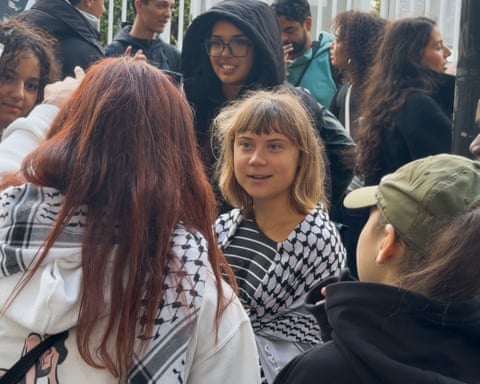 Thunberg, with a keffiyeh around her shoulders, speaking to students