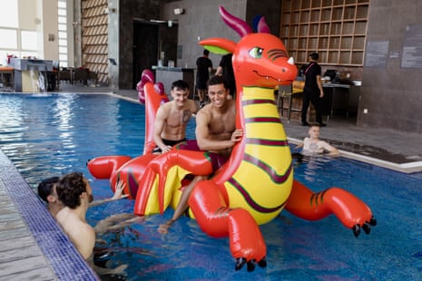 Wales's Dylan Levitt and Brennan Johnson ride an inflatable dragon as they relax after the 1-1 draw with USA.