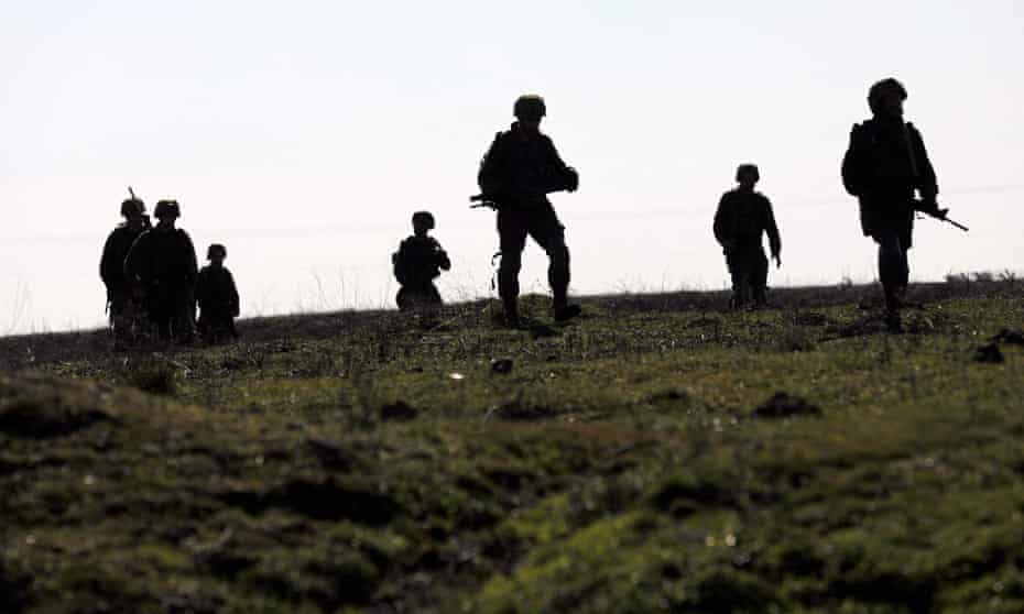 ISRAEL-SYRIA-CONFLICT-GOLAN<br>Israeli soldiers walk near Moshav Sha'al in the Israeli-annexed Golan Heights on February 9, 2022. - Israel launched strikes against targets in Syria early today, hitting anti-aircraft batteries in response to a missile fired from Syria, the military said. (Photo by JALAA MAREY / AFP) (Photo by JALAA MAREY/AFP via Getty Images)