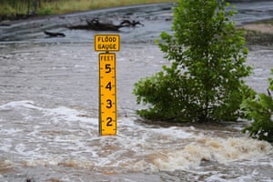 A flood gauge marks the height of water flowing